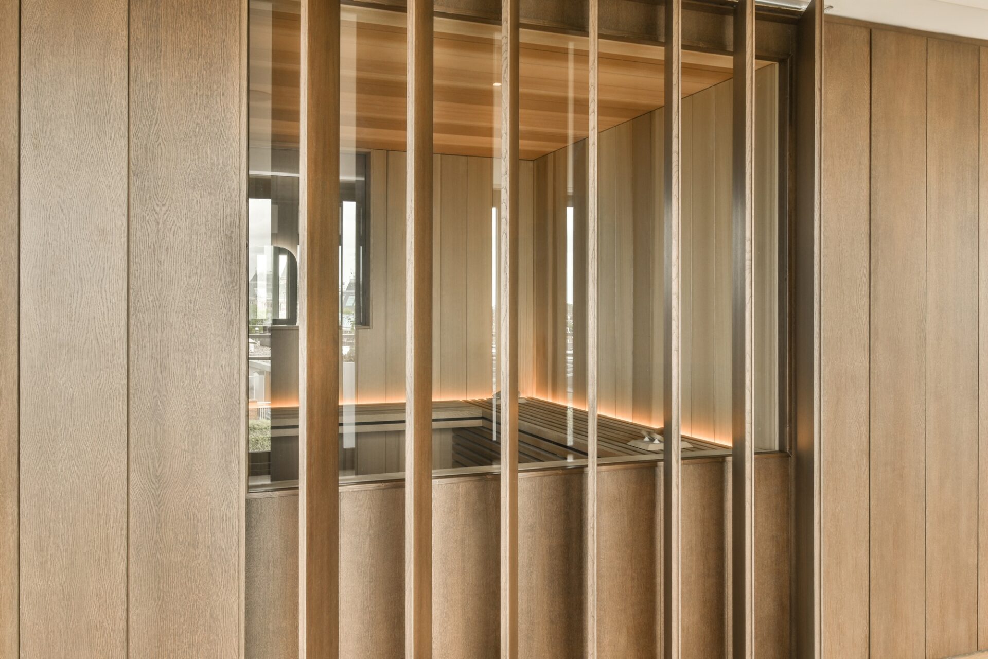 a room with wooden partitions and a bench in it