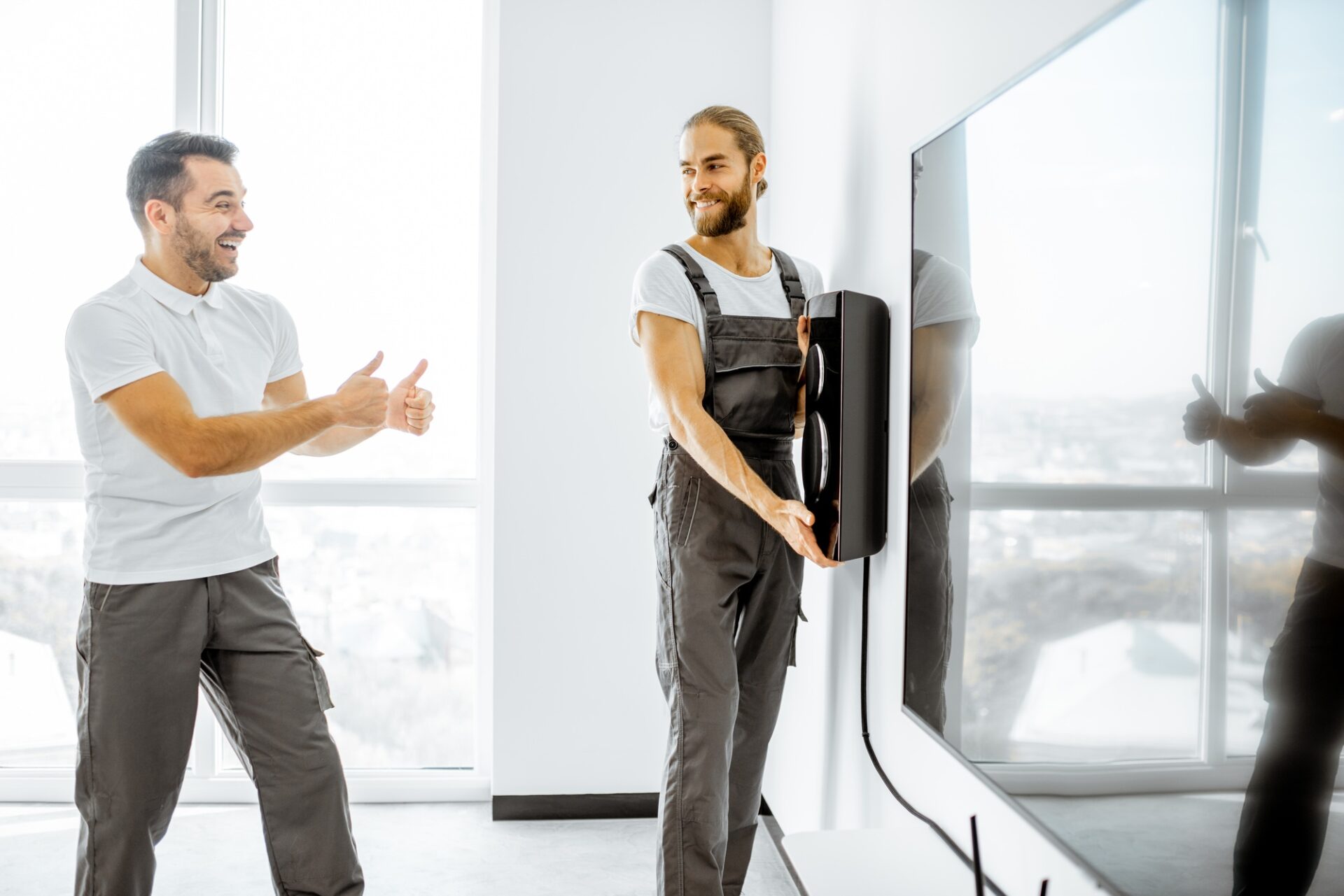 workmen installing audio system at home