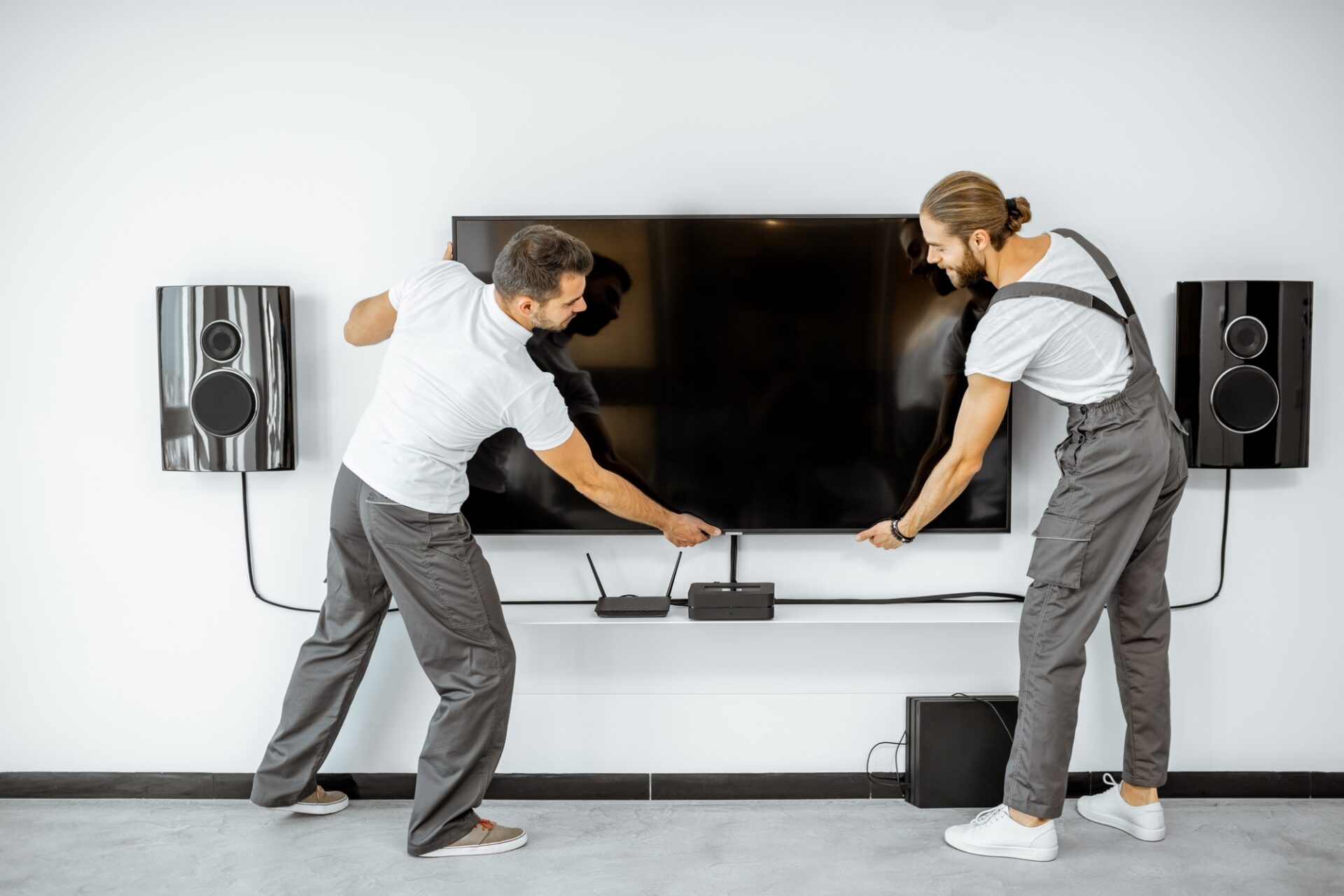 workmen installing television at home
